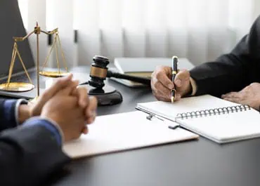 Lawyer taking notes during a consultation symbolizing bankruptcy law