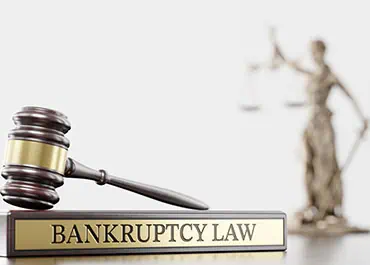 Gavel and book labeled Bankruptcy Law with justice scales in the background