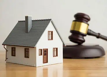 House and gavel symbolizing real estate law, property disputes and homeownership rights